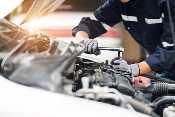 Mechanic working on car's engine. Concept of car inspection service and car repair service.